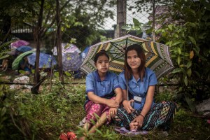 Factory workers listen to their Union Leader speak on October 13, 2015. On August 29 2015, the government of Myanmar announced a minimum wage of 3,600 kyats (about 3 US$). This slight pay raise was met with hostilities by factory owners in the Garment Industries who either refused to increase pay at all, made layoffs to keep expenses the same or cut overtime pay and benefits. Even those garment factory workers who have seen a increase in their daily wages have seen very little change in their salaries overall.