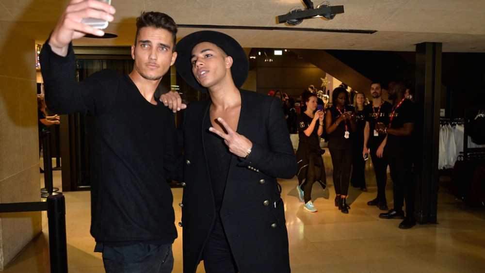 Olivier Rousteing and a die-hard fan inside the H&M Champs-Elysees flagship store