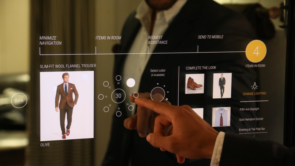 A Polo Ralph Lauren associate trying out the interactive fitting room.