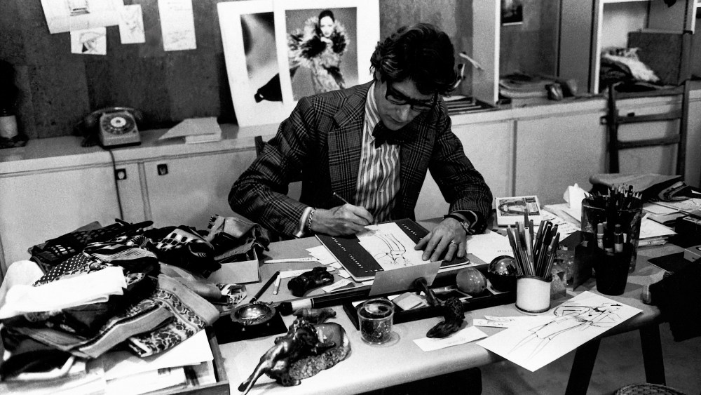 Yves Saint Laurent at his desk in 1976