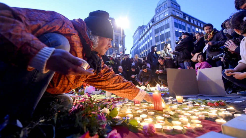 People light candles at the Place de la Bourse in Brussels following the attacks.