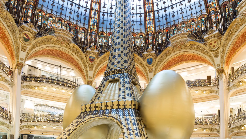 Maurizio Cattelan's giant blow-up Eiffel Tower under Galeries Lafayette's historic cupola.