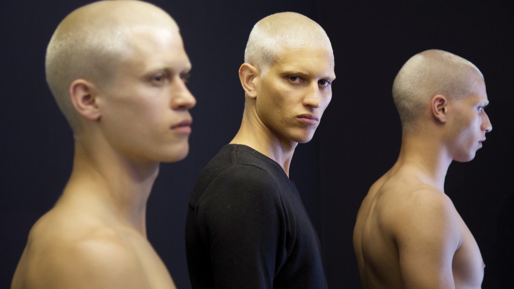 Model John Kolic backstage at Givenchy, for which his hair was bleached at L'Atelier Blanc.
