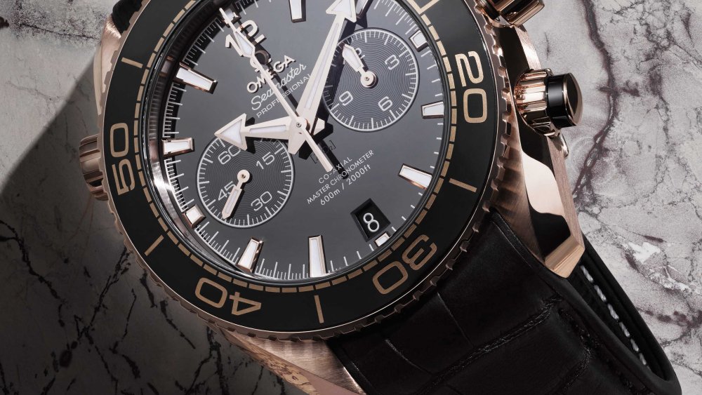 Omega’s Seamaster Planet Ocean coaxial master chronometer, 45.5-mm. sedna gold on black leather strap with rubber lining.