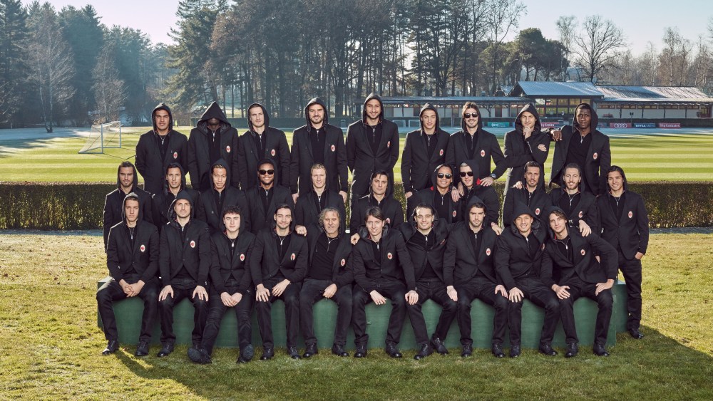 AC Milan players wearing the new uniform designed by Diesel and posing with Renzo Rosso.
