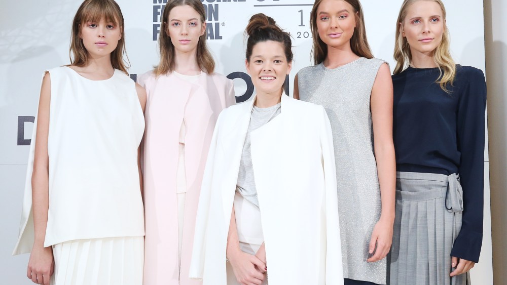 Melbourne Fashion Festival National Designer Award 2017 winner Kacey Devlin (center) flanked by models in her winning collection.