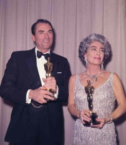 American actor Gregory Peck with his Oscar after winning his first, after five nominations, as he poses with American actress Joan Crawford, who is holding the Oscar awarded to Anne Bancroft, at the Academy Awards at Santa Monica Civic Auditorium in Los Angeles, Ca., . Peck won best actor for "To Kill a Mockingbird" and Bancroft won for best actress in "The Miracle WorkerOscars Gregory Peck Joan Crawford, Santa Monica, USA