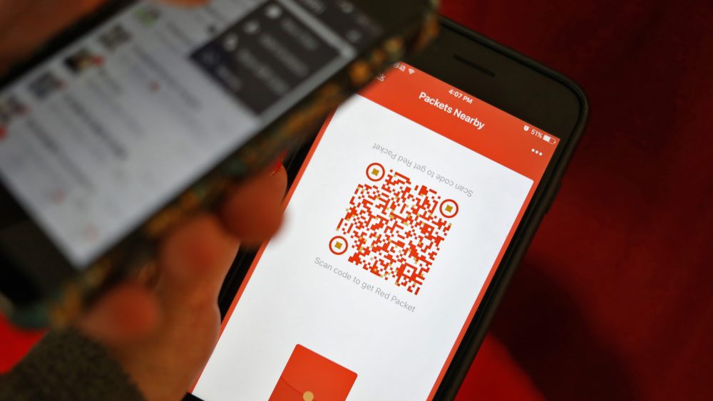 People using WeChat to scan for red packets during Chinese New Year.