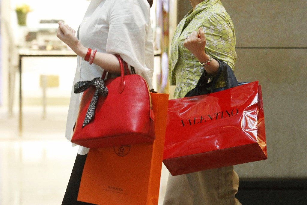 Mainland Chinese Tourists Are Seen with Luxury Brand Shopping Bags in Hong Kong China 17 May 2011 the Strength of the Chinese Yuan Against the Hong Kong Dollar Makes Shopping in Hong Kong Inexpensive For the Emerging Middle Classes of China who Often Travel to Hong Kong to Buy Luxury Goods and Even Apartments in the City China Hong KongChina Hong Kong Luxury Shopping - May 2011