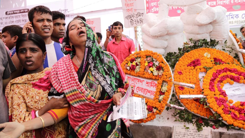 A relative of a Rana Plaza victim cries at a 2016 memorial created for the garment factory workers.