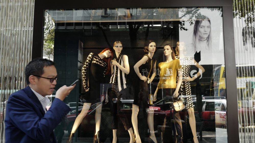 A man walks by a Louis Vuitton shop in Hong Kong.