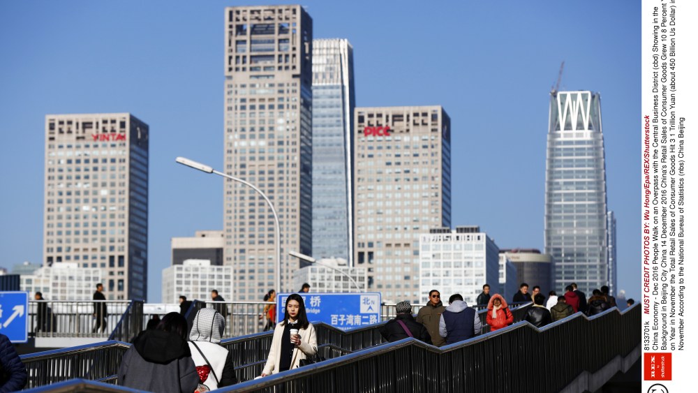 People Walk on an Overpass with the Central Business District (cbd) Showing in the Background in Beijing City China 14 December 2016 China's Retail Sales of Consumer Goods Grew 10 8 Percent Year on Year in November the Total Retail Sales of Consumer Goods Hit 3 1 Trillion Yuan (about 450 Billion Us Dollar) in November According to the National Bureau of Statistics (nbs) China BeijingChina Economy - Dec 2016