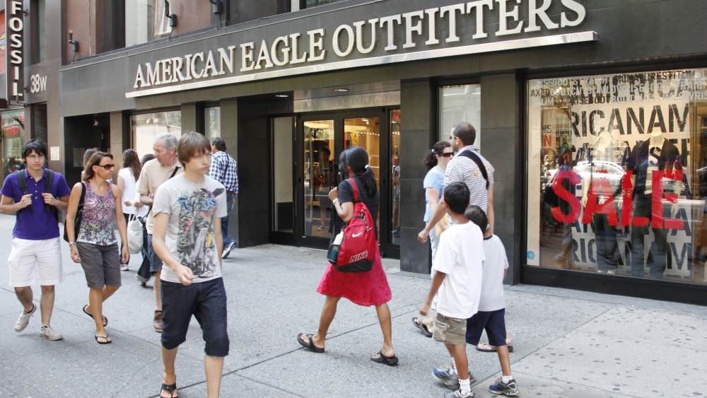 Youngsters pass an American Eagle Outfitters clothing store, in New York. Retail sales managed a modest increase in July after two consecutive declines, but the strength was concentrated in higher sales of autos and gasoline. Most other retailers saw their sales fallEconomy, New York, USA