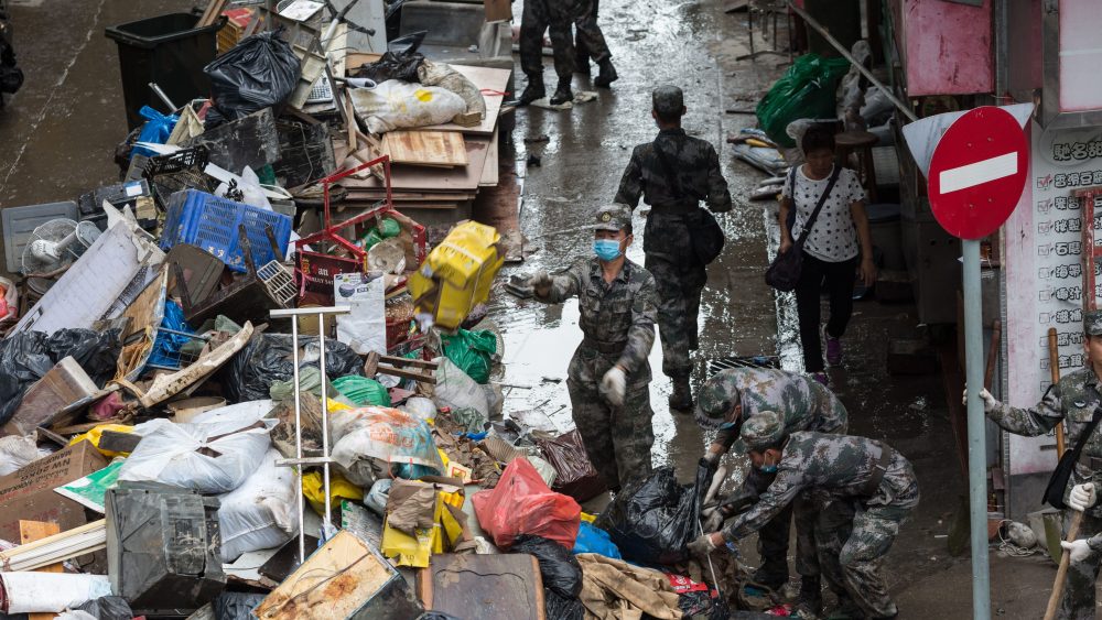 China's People Liberation Army (PLA) soldiers help to clean up debris brought by typhoon Hato in Macau.