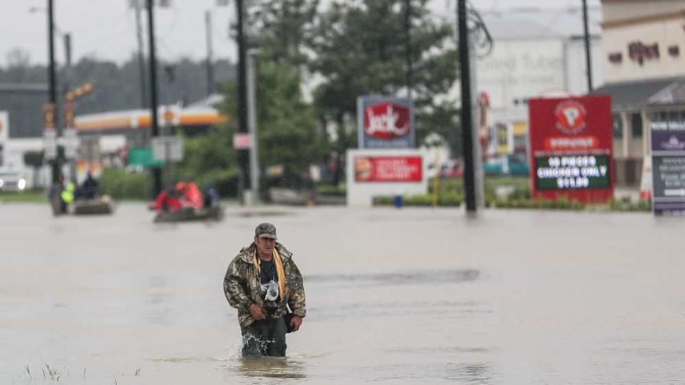 A man walks through floodwaters in the aftermath of Hurricane Harvey in Houston, Texas, USA, 29 August 2017. Hurricane Harvey made landfall on the south coast of Texas as a major hurricane category 4. The last time a major hurricane of this size hit the United States was in 2005.Hurricane Harvey aftermath, Houston, USA - 29 Aug 2017