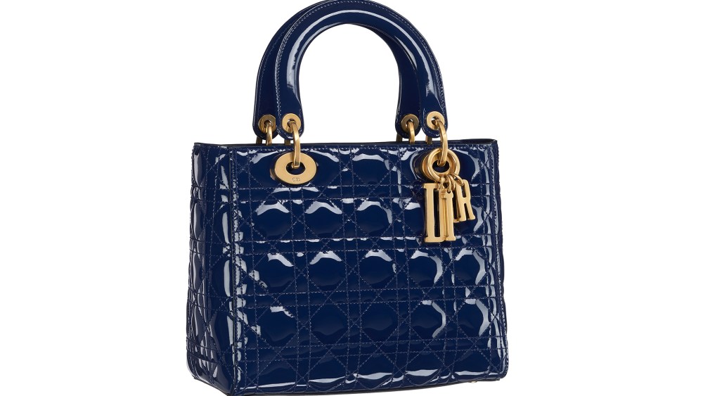 Lady Dior bag in indigo color Cannage glazed calfskin, “D.I.O.R” block charms in aged gold tone metal. Large strap. Autumn-Winter 2017 Ready-to-Wear collection.
