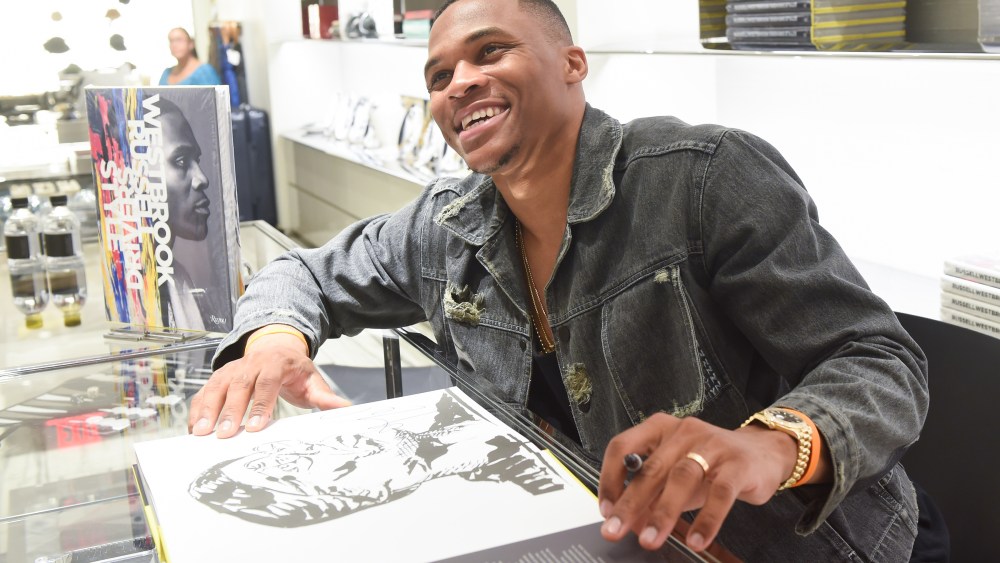 Russell Westbrook signs his new book during an event at Barneys.