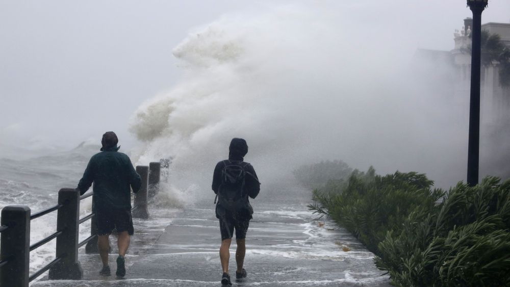 Pedestrians walk into huge waves crashing over The Battery as Tropical Storm Irma hits Charleston, S.CHurricane Irma South Carolina, Charleston, USA - 11 Sep 2017