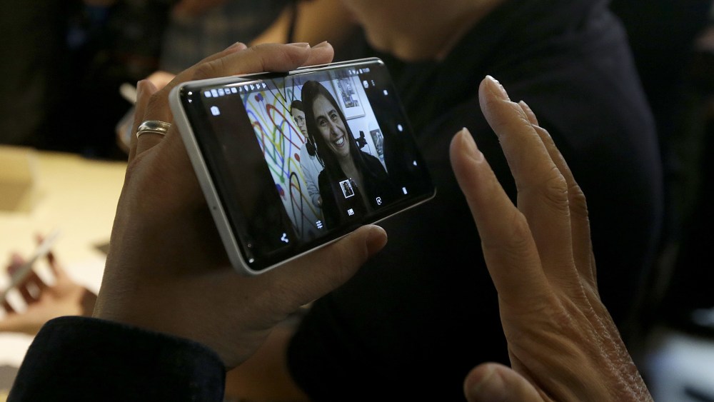 A woman holds up one of the new Google Pixel phones at a Google event at the SFJAZZ Center in San FranciscoGoogle Showcase, San Francisco, USA - 04 Oct 2017