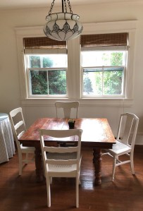 Breakfast area off of kitchen with original table and four chairs.