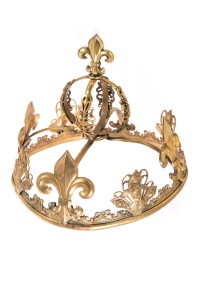 A gold-plated child's crown surmounted with repeated fleur de lis symbols. Worn by Shirley Temple in "The Little Princess" (20th Century Fox, 1939).