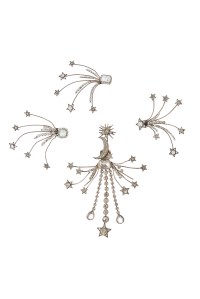 A group of four silver-plated celestial costume ornaments with simulated diamond star sprays.  Worn by Greta Garbo in "Camille" (MGM, 1937). Some of the ornaments were additionally worn by Alice Faye in the film "In Old Chicago" (20th Century Fox, 1938); Lucille Ball in "Du Barry was a Lady" (MGM, 1943); and Mae West in "The Heat's On" (Columbia Pictures, 1943).