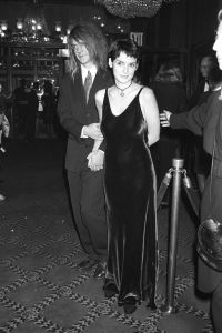 Actress Winona Ryder dressed in a plum-colored slip dress and heart pendant necklace and her date, actor David Pirner at 'The Age of Innocence' premiere on September 14, 1993 in New York..Article title: 'EyeAge of Innocence' Party, New York