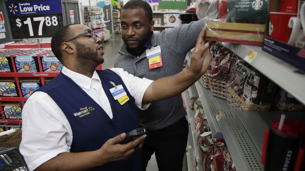 Walmart employee Kenneth White, left, is coached by Shabazz Bonner while using an inventory app during a class at the Walmart Academy at the store in North Bergen, N.J. The retail industry is being radically reshaped by technology and nobody feels that disruption more starkly than the 16 million Americans working as shelf stockers, salespeople and cashiersFuture of Work-Changing Retail, North Bergen, USA - 08 Nov 2017