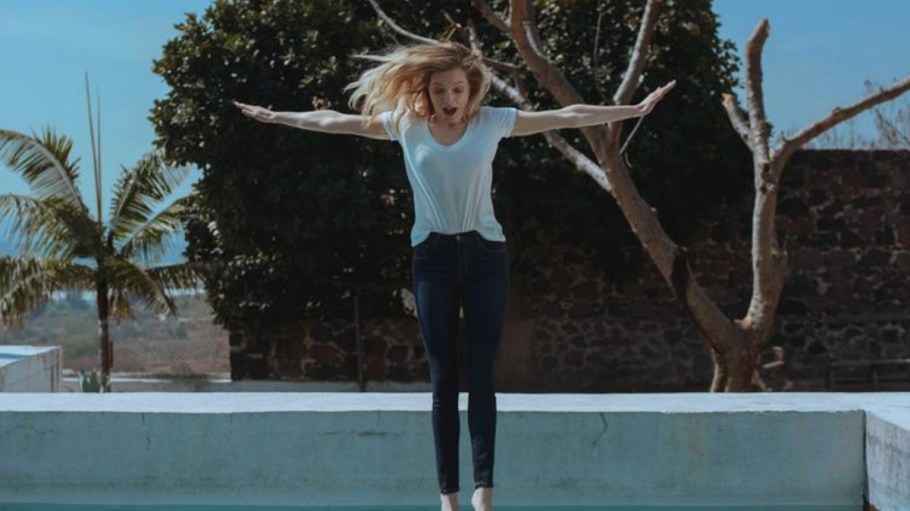 girl jumping into pool