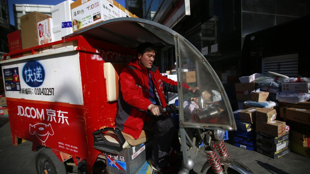 A Chinese 'kuadi' or delivery man drives his three-wheel delivery cart to deliver packages to customers at a distribution centre for JD.com on Singles Day, otherwise known as '11.11' Global Shopping Festival, in Beijing, China, 11 November 2017. Singles Day is the largest online shopping festival in the world and Chinese consumers are expected to spend billions on bargains during the one-day e-commerce shopping spree.Singles Day or 11.11 Global Shopping Festival, Beijing, China - 11 Nov 2017