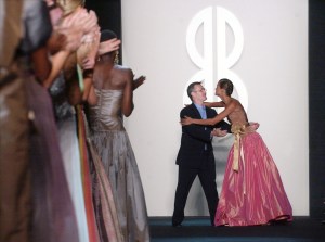 Michael Vollbracht, center, embraces a model after the Bill Blass spring 2004 collection, which featured his designs, during the Mercedes Benz Fashion Week in New YorkFASHION BLASS, NEW YORK, USA