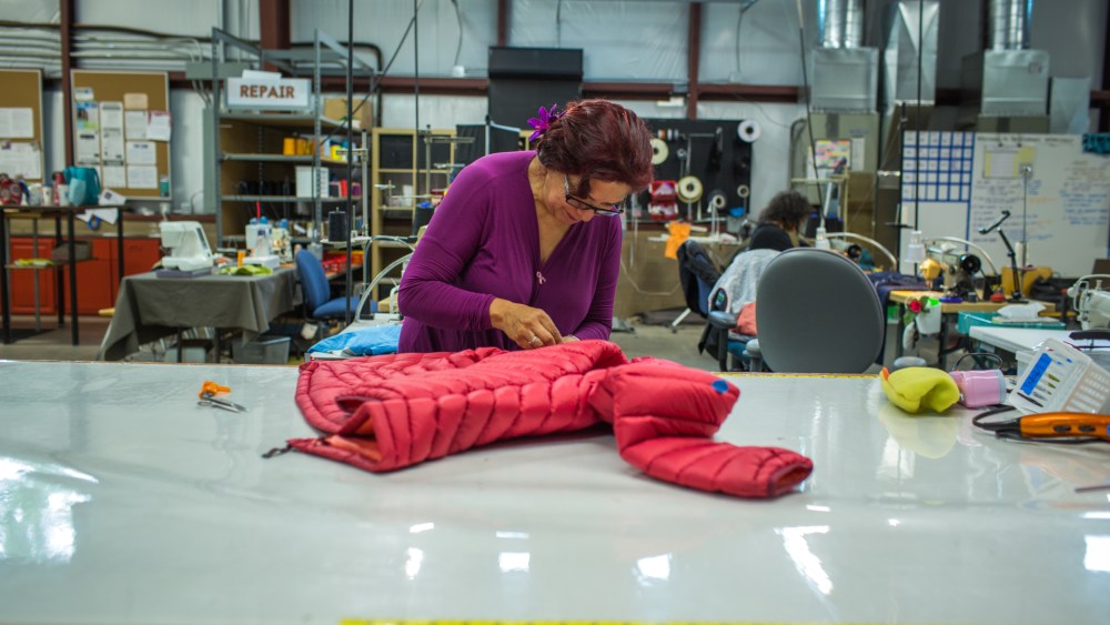 An employee works on a Patagonia jacket at The Renewal Workshop.