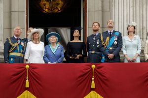 From left, Prince Charles, Prince Andrew, Camilla the Duchess of Cornwall, Britain's Queen Elizabeth II, Meghan the Duchess of Sussex, Prince Harry, Prince William and his wife Kate the Duchess of Cambridge, as they watch a flypast of Royal Air Force aircraft pass over Buckingham Palace in London