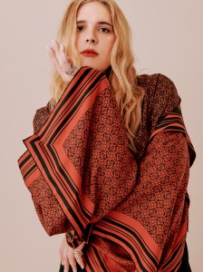 LoeweÕs silk shirt and Proenza SchoulerÕs cotton trousers, both available at Saks Fifth Avenue; Mounser earring; Spinelli Kilcollin earring and rings; Calvin Klein 205W39NYC boots.