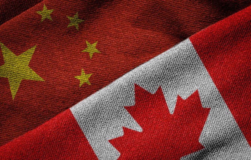 3D rendering of the flags of China and Canada on woven fabric texture.