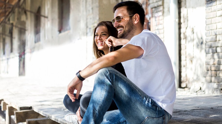 Casual happy couple dating and sitting outdoor