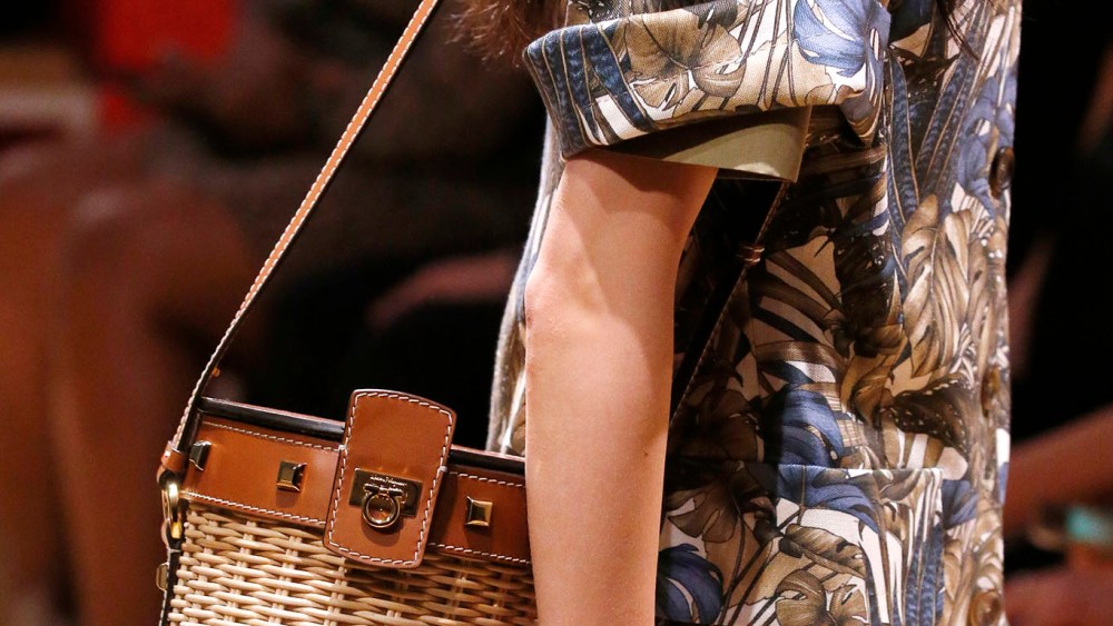 Salvatore Ferragamo women’s creative director Paul Andrew updated the classic straw bucket bag with sophisticated leather inserts, metallic studs and the brand’s signature Gancini detail. Charming as a Mediterranean summer. 