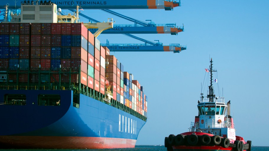 A tug boat moves into position with a Hyundai container ship in the Port of Los Angeles