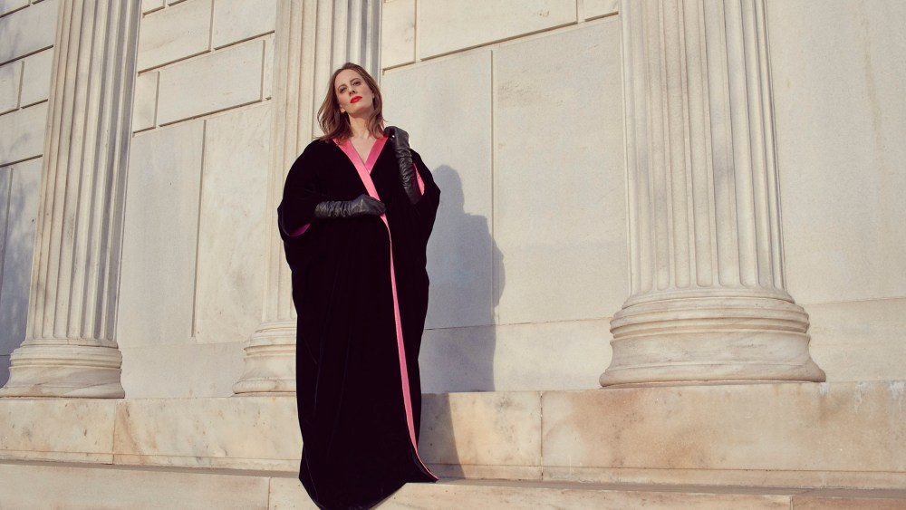 Liz Goldwyn in a floor-length black velvet opera coat lined in pink satin by Mr. Blackwell.