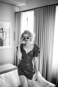 Julia Garner in Area’s lambskin leather dress. Adam Selman x Le Specs sunglasses.