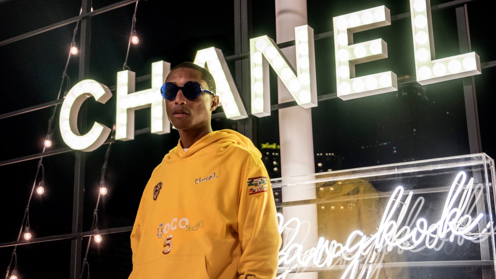 Pharrell in Bangkok wearing a design from his upcoming capsule with Chanel.