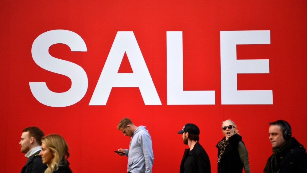 Christmas shoppers pass a sale sign on Oxford Street in London, Britain, 20 December 2018. The Office for National Statitsics figures showed sales rose in November to 1.4 per cent from October.Christmas shopping in Britain, London, United Kingdom - 20 Dec 2018
