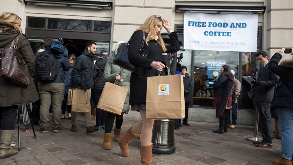 Federal employees and family members (C) that have been affected by the ongoing shutdown of the US federal goverment leave with free meals provided to them by World Central Kitchen, at Jose Andres' ThinkFoodLab in Washington, DC, USA, 16 January 2019. The disaster relief nonprofit World Central Kitchen, led by celebrity chef Jose Andres, opened a Washington DC feeding site 16 January to try to help some of the 800,000 federal workers that are either working without pay or have been furloughed. Free hot meals and to-go meals will be provided everyday, including weekends. The shutdown began 22 December 2018 and is now the longest in US history with no clear end in sight.Chef Jose Andres opens a World Central Kitchen feeding site to provide food to US federal government employees in need, Washington, USA - 16 Jan 2019