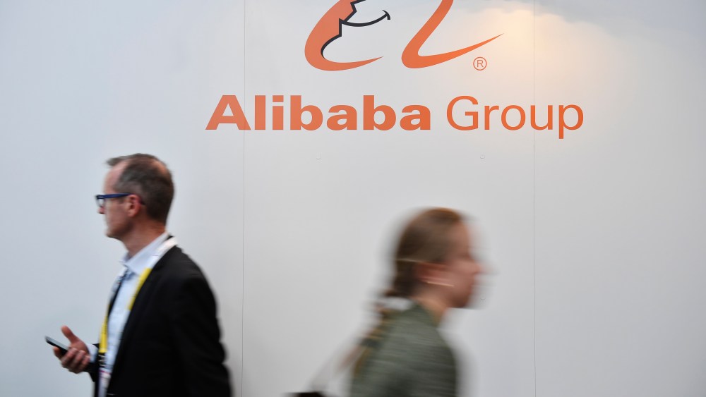 Visitors passes by a Alibaba Group logo during the Vivatech startups and innovation fair in Paris.