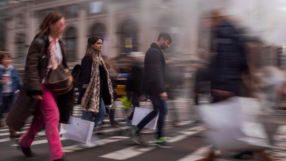 Shoppers carry their purchases as they walk though the steam coming from the underground along Fifth Avenue on Black Friday in New York, . Shoppers were on the hunt for deals and were at the stores for entertainment Friday as malls opened for what is still one of the busiest days of the year, even as the start of the holiday season edges ever earlierHoliday Shopping Black Friday, New York, USA - 25 Nov 2016