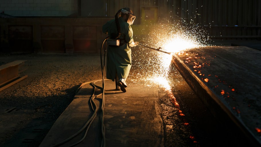Sparks fly as an employee performs a quality check on a steel slab at a plant in Nanticoke, Ontario, Canada.