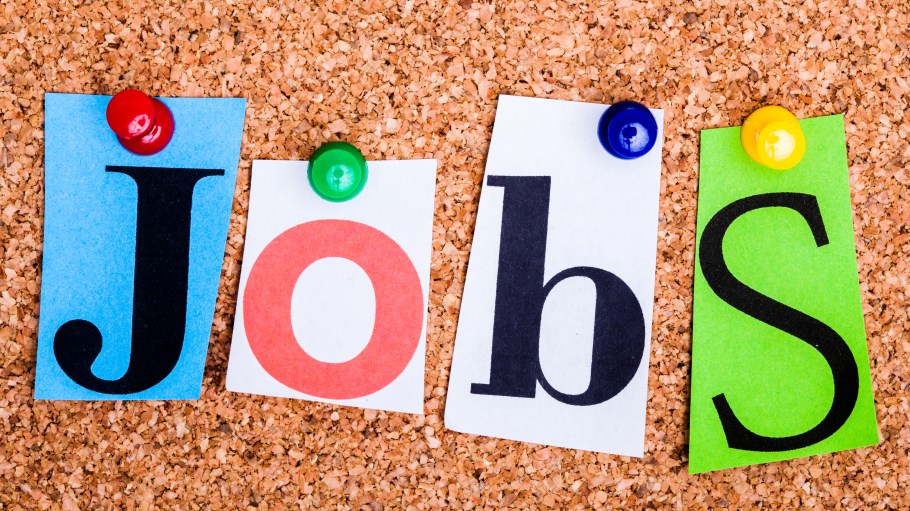 The word Jobs in cut out magazine letters pinned to a cork notice board