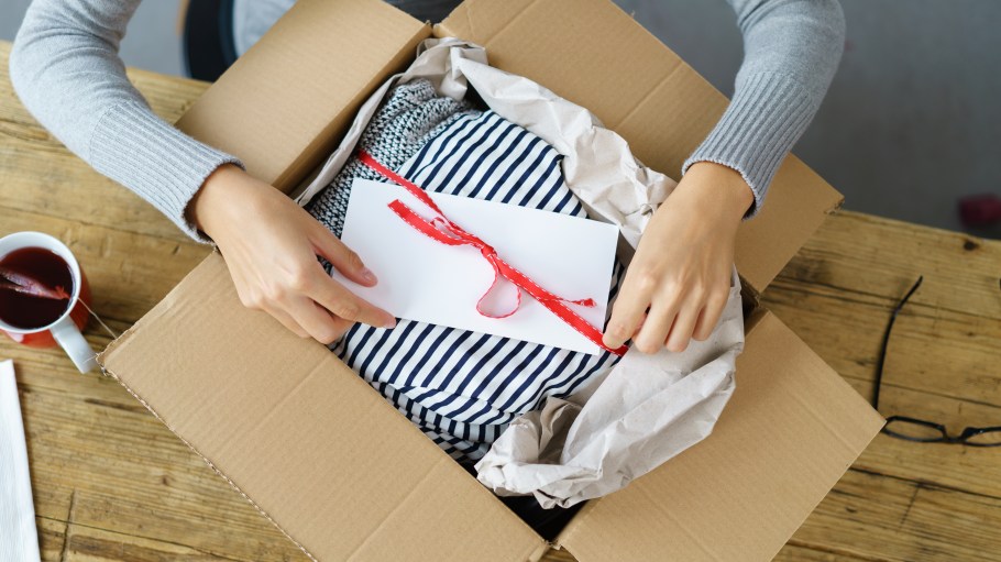 woman opening box of clothing