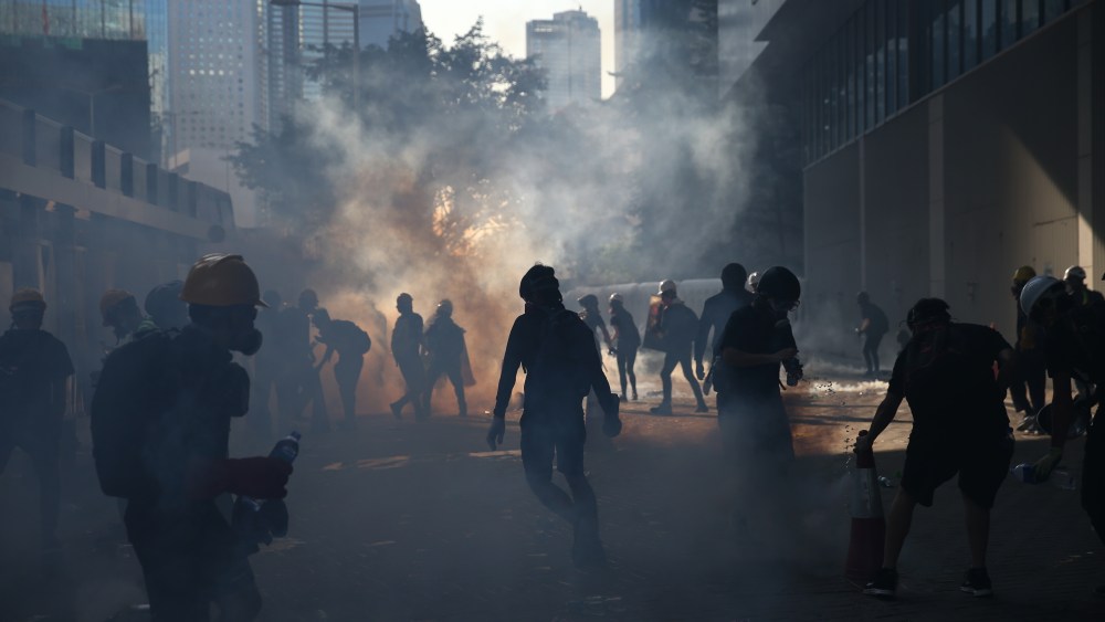 Anti-extradition protesters react after police fired tear gas at them in the Admiralty area of Hong Kong, China, 05 August 2019. Hong Kong is in the midst of a day of citywide strike following a ninth consecutive weekend of multiple anti-extradition rallies and intense clashes between demonstrators and police over the now suspended extradition bill to China.Anti-extradition protesters clash in Hong Kong, China - 05 Aug 2019