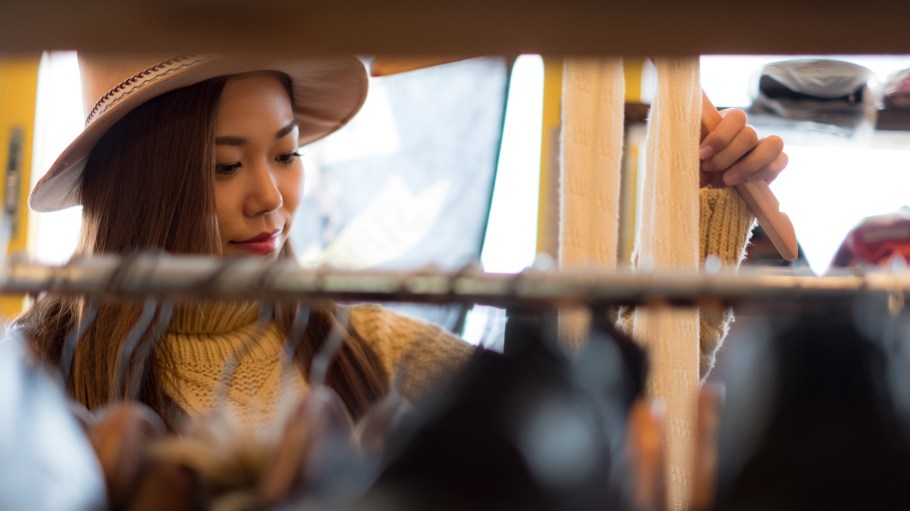 A woman enjoying casual clothes shopping in a clothing store.